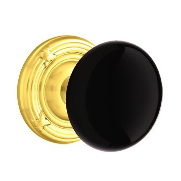 Passage Ebony Porcelain Knob With Ribbon & Reed Rosette  in Polished Brass
