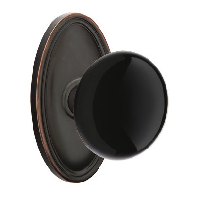 Passage Ebony Porcelain Knob With Oval Rosette in Oil Rubbed Bronze