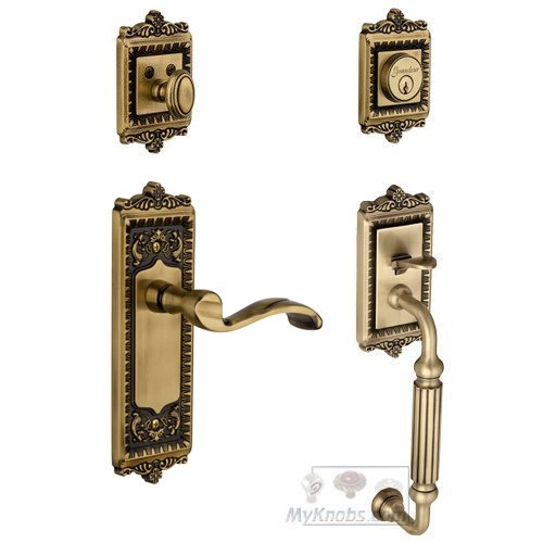 Windsor with "F" Grip and Portofino Right Handed Door Lever in Vintage Brass