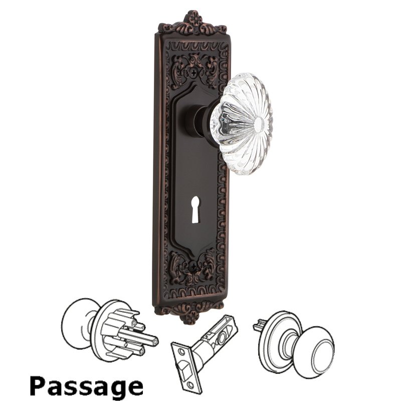 Passage Egg & Dart Plate with Keyhole and Oval Fluted Crystal Glass Door Knob in Timeless Bronze