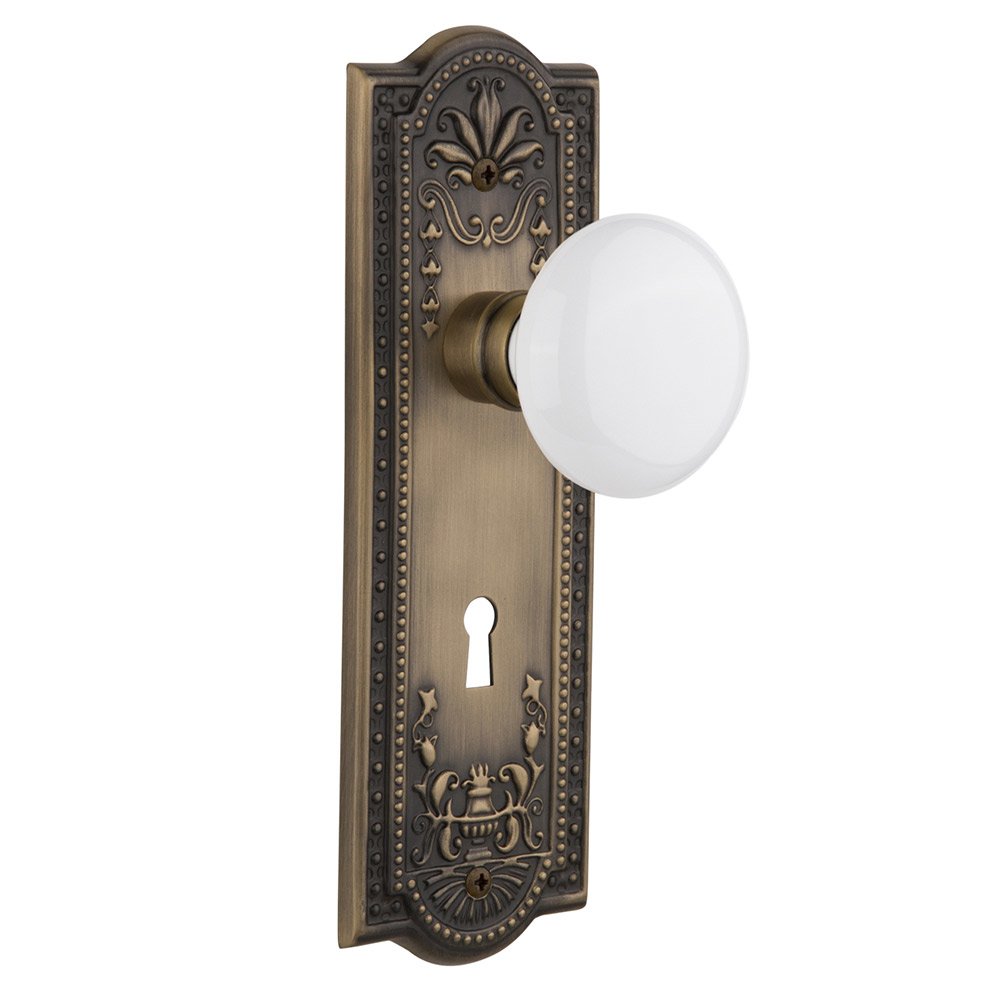 Passage Meadows Plate with Keyhole and White Porcelain Door Knob in Antique Brass