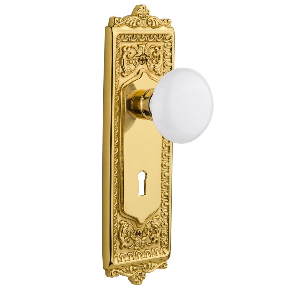 Single Dummy Egg & Dart Plate with Keyhole and White Porcelain Door Knob in Polished Brass