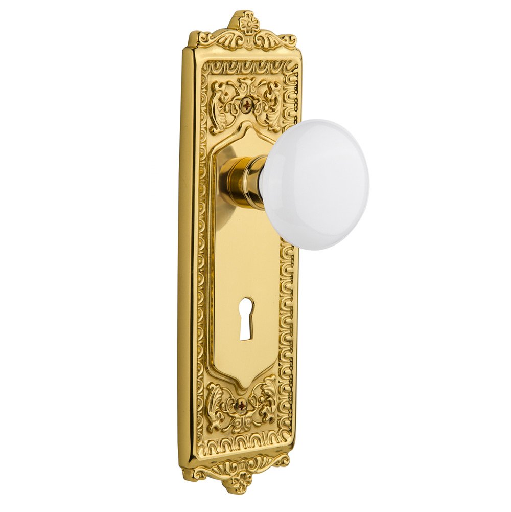 Passage Egg & Dart Plate with Keyhole and White Porcelain Door Knob in Polished Brass