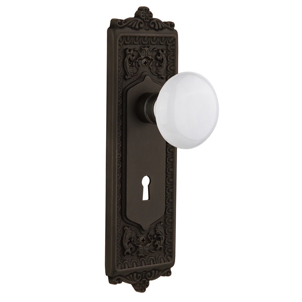 Passage Egg & Dart Plate with Keyhole and White Porcelain Door Knob in Oil-Rubbed Bronze