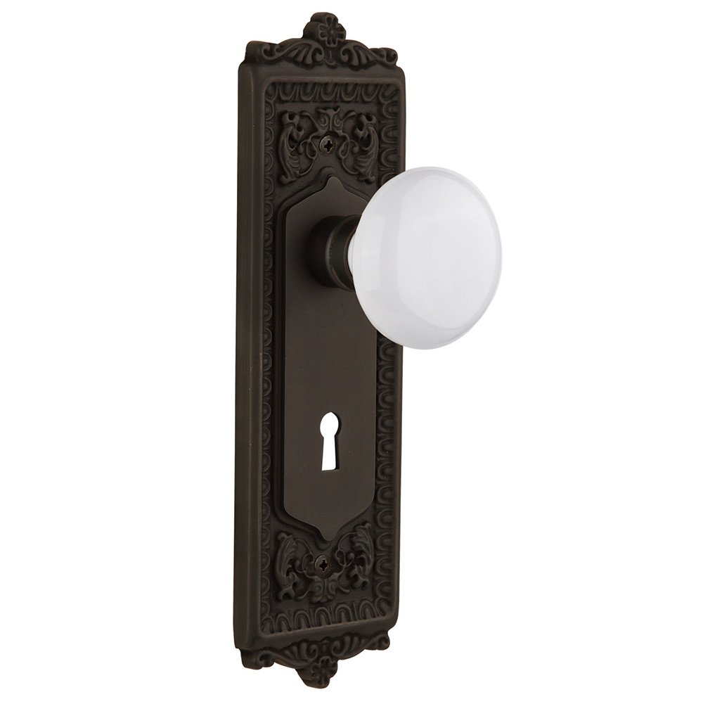 Double Dummy Egg & Dart Plate with Keyhole and White Porcelain Door Knob in Oil-Rubbed Bronze