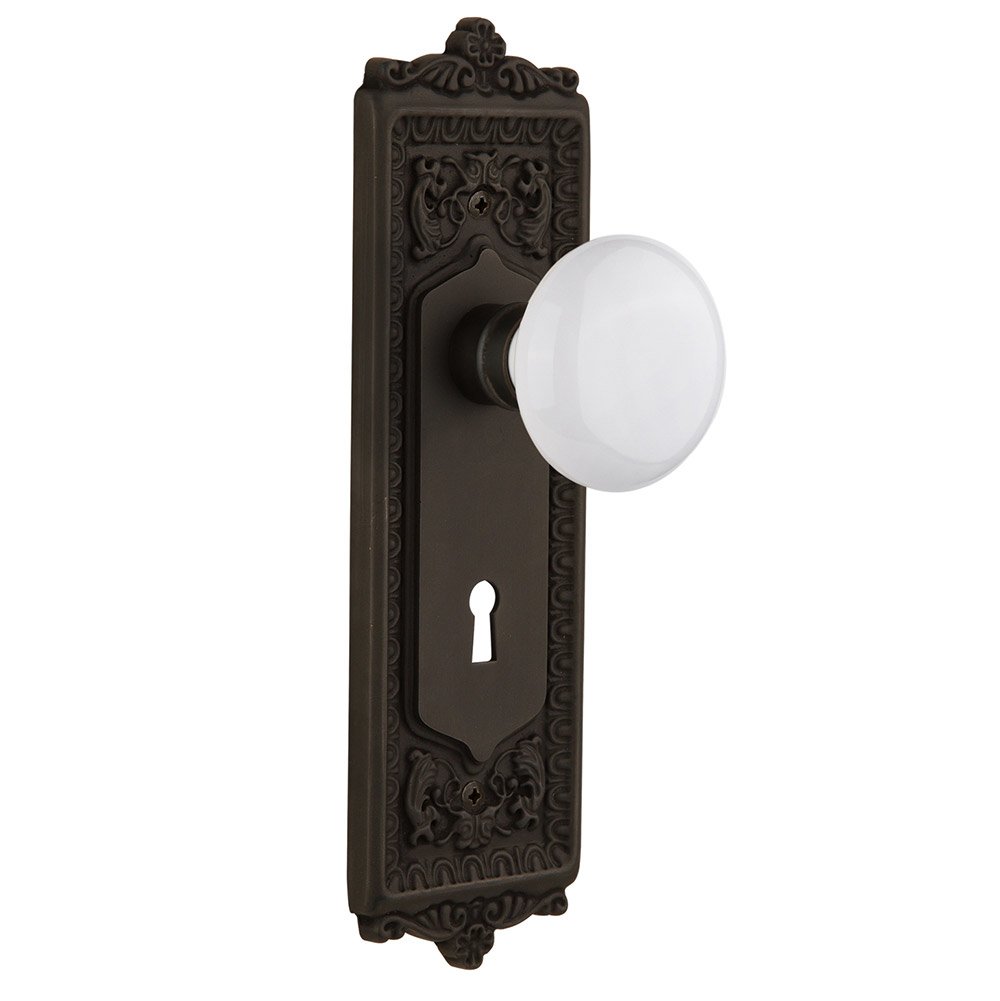 Single Dummy Egg & Dart Plate with Keyhole and White Porcelain Door Knob in Oil-Rubbed Bronze
