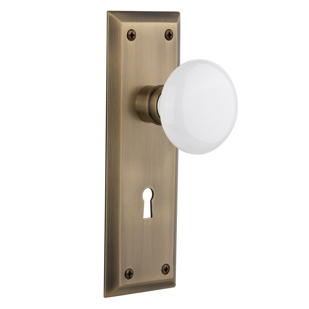 Passage New York Plate with Keyhole and White Porcelain Door Knob in Antique Brass